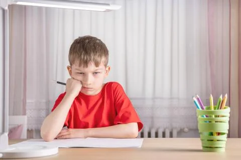 The boy does not want to do homework for school Foto stock