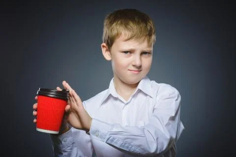 Boy does not want to drink coffee. The child does not like the beverage Stock Photos