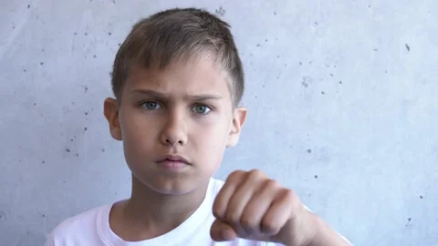 Boy does sport exercises, shows how to box and fight with his fists and hands Stock-Footage 131915248