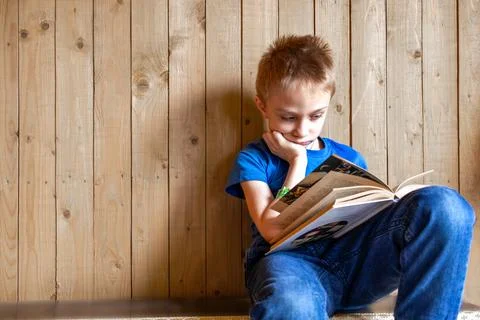 Boy doesn't want read. Learning difficulties. Laziness. Boredom. copy space Stock Photos