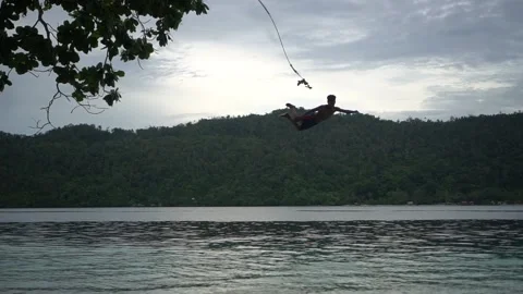 The boy doing a beatiful jump into water Stock Footage 157968467