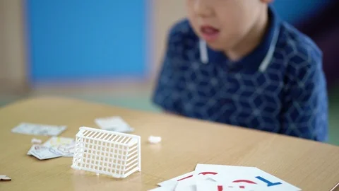 The boy is doing the breathing exercise at speech therapy session Stock Footage 93777049