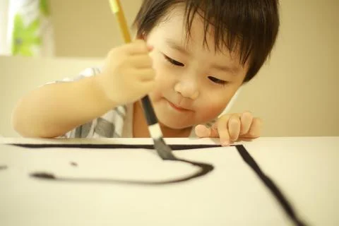 Boy doing calligraphy Foto stock