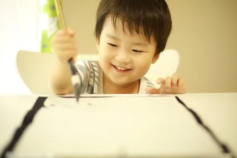 Boy doing calligraphy Stock Photos