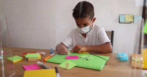 Boy doing collage in preschool classroom wearing face protective mask Stock Footage 141051045