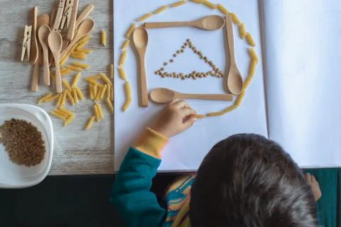 Boy doing crafts and homework at home during confinement by covid-19 Stock Photos