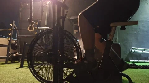 A boy is doing exercise and cycling in a gym. Healthy lifestyle. Stock Footage 285633925