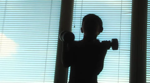 Boy doing gymnastics with dumbbells Stock Footage 48078508