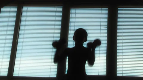 Boy doing gymnastics with dumbbells Stock Footage 48078555