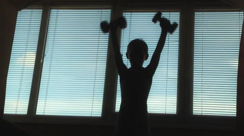 Boy doing gymnastics with dumbbells Stock Footage 48078620