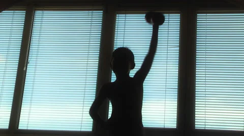 Boy doing gymnastics with dumbbells Stock Footage 48078691