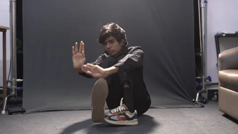 The boy is doing a hand foot moves. popping and locking dance Stock Footage 158725645