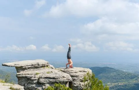 Boy doing a handstand on the mountain Stock Photos
