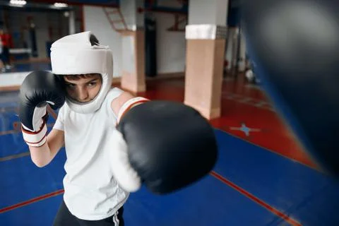 Boy doing his best while boxing, kid is concentrated on fighting Stock Photos