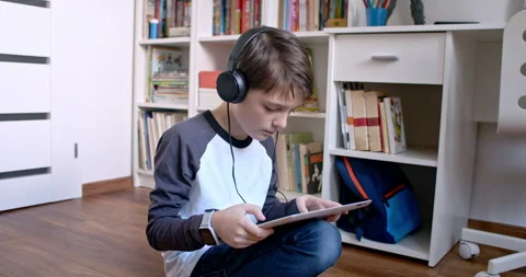 Boy doing his homework on digital tablet at home. Stock Footage 135027543