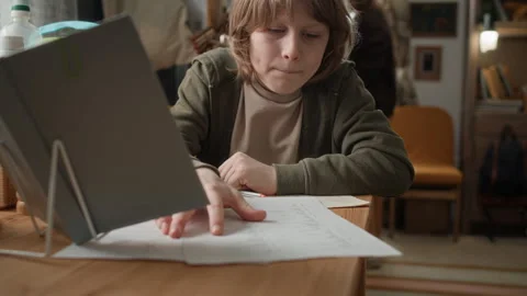 Boy Doing his Homework, his Mother Cooking in Old and Cramped Run Down apartment Stock Footage 333741503