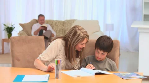 A boy doing his homeworks with his grandmother Stock Footage 1965086
