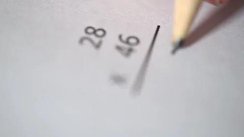 Boy doing his math homework with a pencil on a piece of paper. Multiplication Stock Footage 130661494