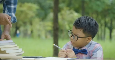 Boy doing home work with serious emotion. Video stock 99322155