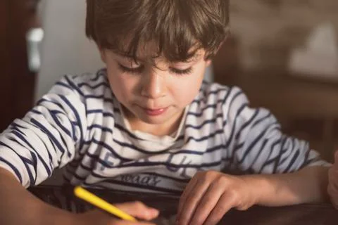 Boy doing homework at home Stock Photos