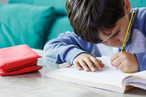 Boy doing homework at home Stock Photos