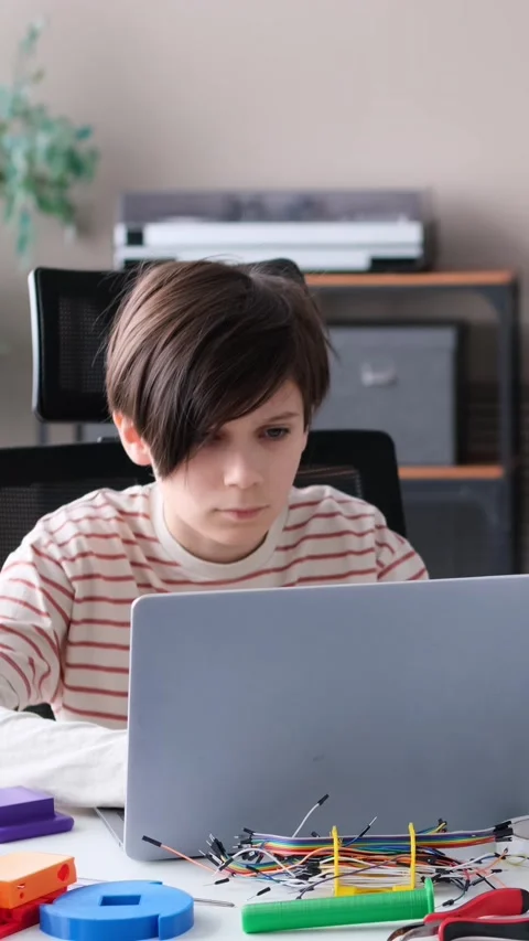 Boy Doing Homework With Laptop And 3D Printer Stock Footage 303929990