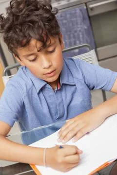 Boy doing homework. Studious schoolboy.. Stock Photos