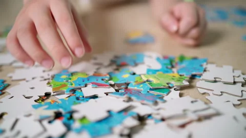 Boy doing jigsaw puzzle Stock Footage 155094280
