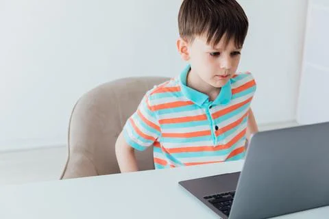 Boy doing learning task at school on computer Stock Photos