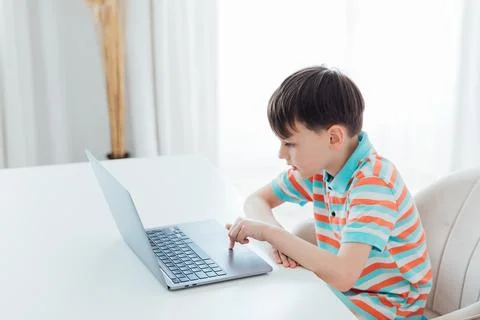Boy doing learning task at school on computer Stock Photos