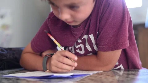 Boy doing school homework with pencil Stock Footage 95358056