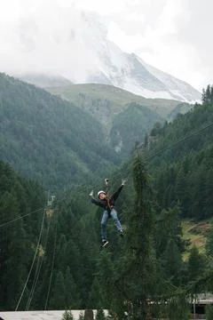 Boy doing a zip wire in the mountains in Zermatt Switzerland Stock Photos