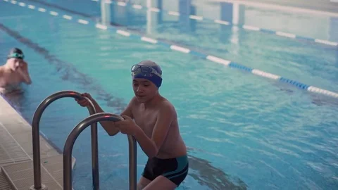 The boy down the stairs to the pool Stock Footage 71499196