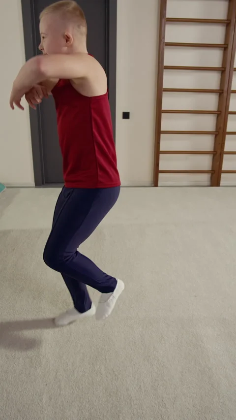 Boy with Down Syndrome Dancing Energetically in Spacious Sports Studio Stock Footage 326638757