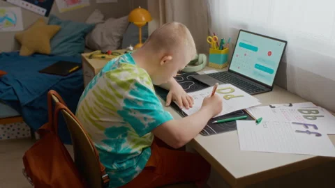 Boy with Down Syndrome Practicing Writing and Learning Alphabet Stock Footage 337570402