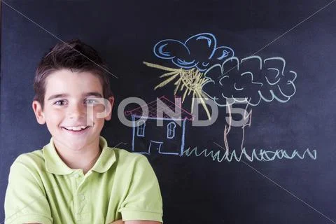 Boy Drawing On The Blackboard