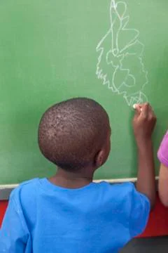 The boy drawing at the blackboard Stock Photos