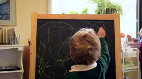 Boy Drawing on Chalkboard in School Stock Footage 46633842