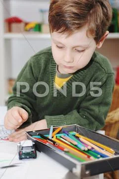 Boy Drawing With Colored Pencils