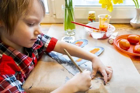 Boy drawing the ears of a handmade Easter bunny made of cardboard. Preparatio Stock Photos
