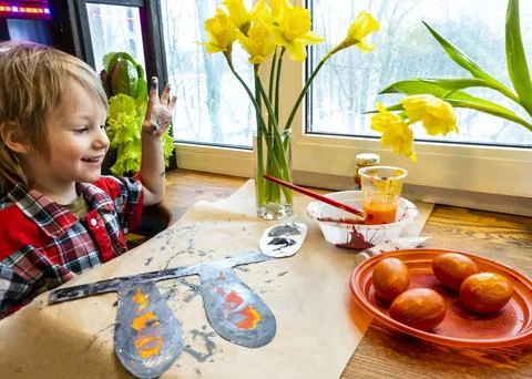 Boy drawing the ears of a handmade Easter bunny made of cardboard. Preparatio Stock Photos
