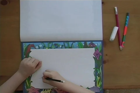 Boy drawing on a notebook Video stock 65601