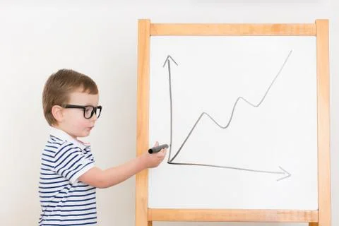 Boy drawing sales report on the board Stock Photos
