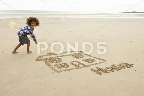 Boy drawing in sand Stock Photos