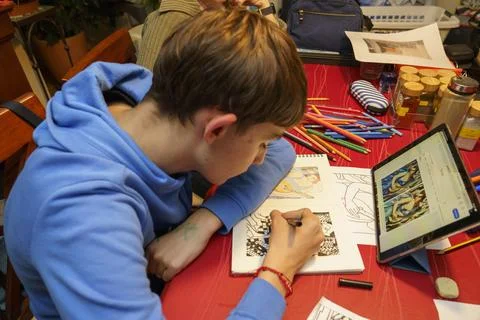 A boy is drawing on a tablet Stock Photos