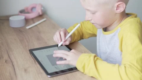 The boy draws a 3D model at home on a 3D stick tablet Stock Footage 134589010