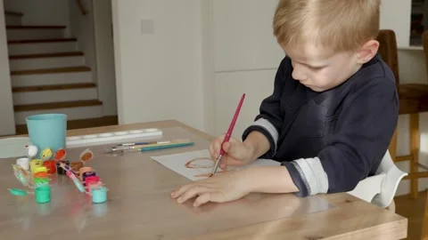 Boy draws with acrylic paint on a sheet of paper, a boy of European appearance 4 Stock Footage 304731206