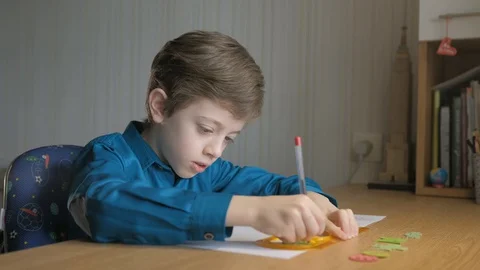 Boy draws with ballpoint pen patterns using the graphical ruler Stock Footage 129402867