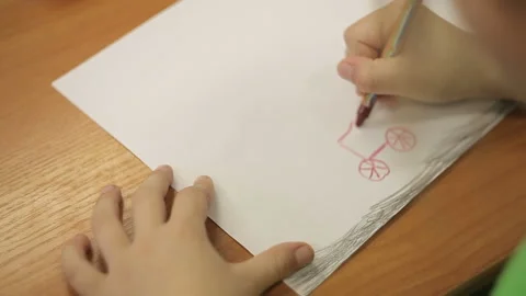 A boy draws a car with a pencil Stock Footage 118579528