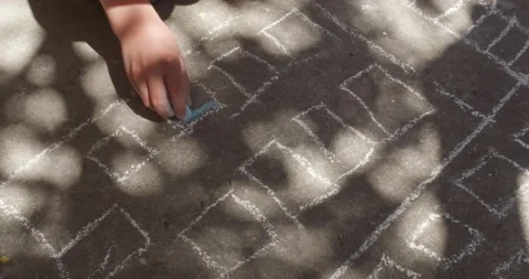 Boy draws with chalk on the asphalt  Stock Footage 339321650